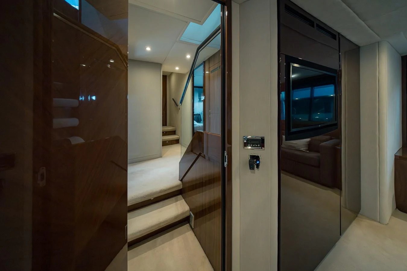 A sleek and modern hallway with polished wood finishes and soft lighting. aboard 4 LIFE Yacht for Sale