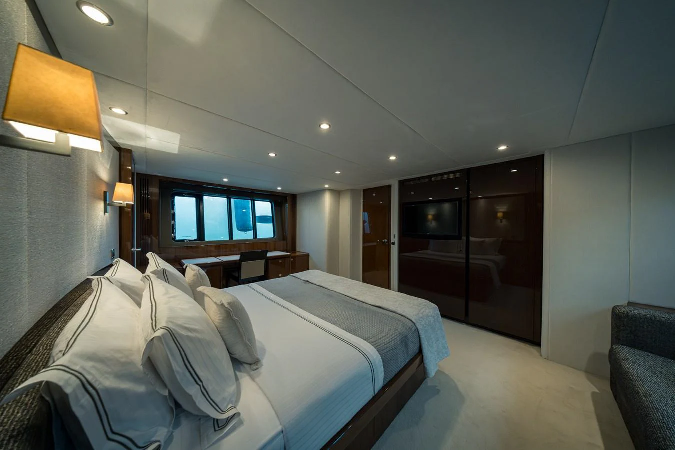 The master stateroom features a spacious bed, elegant lighting, and ample storage, creating a luxurious retreat. aboard 4 LIFE Yacht for Sale