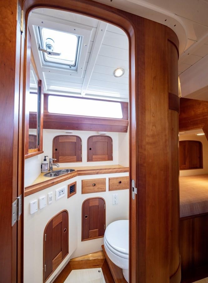 a bathroom with a toilet and a sink aboard PRIVATE Yacht for Sale