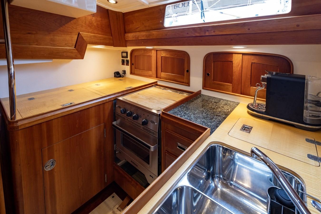 a kitchen with a sink and stove aboard PRIVATE Yacht for Sale