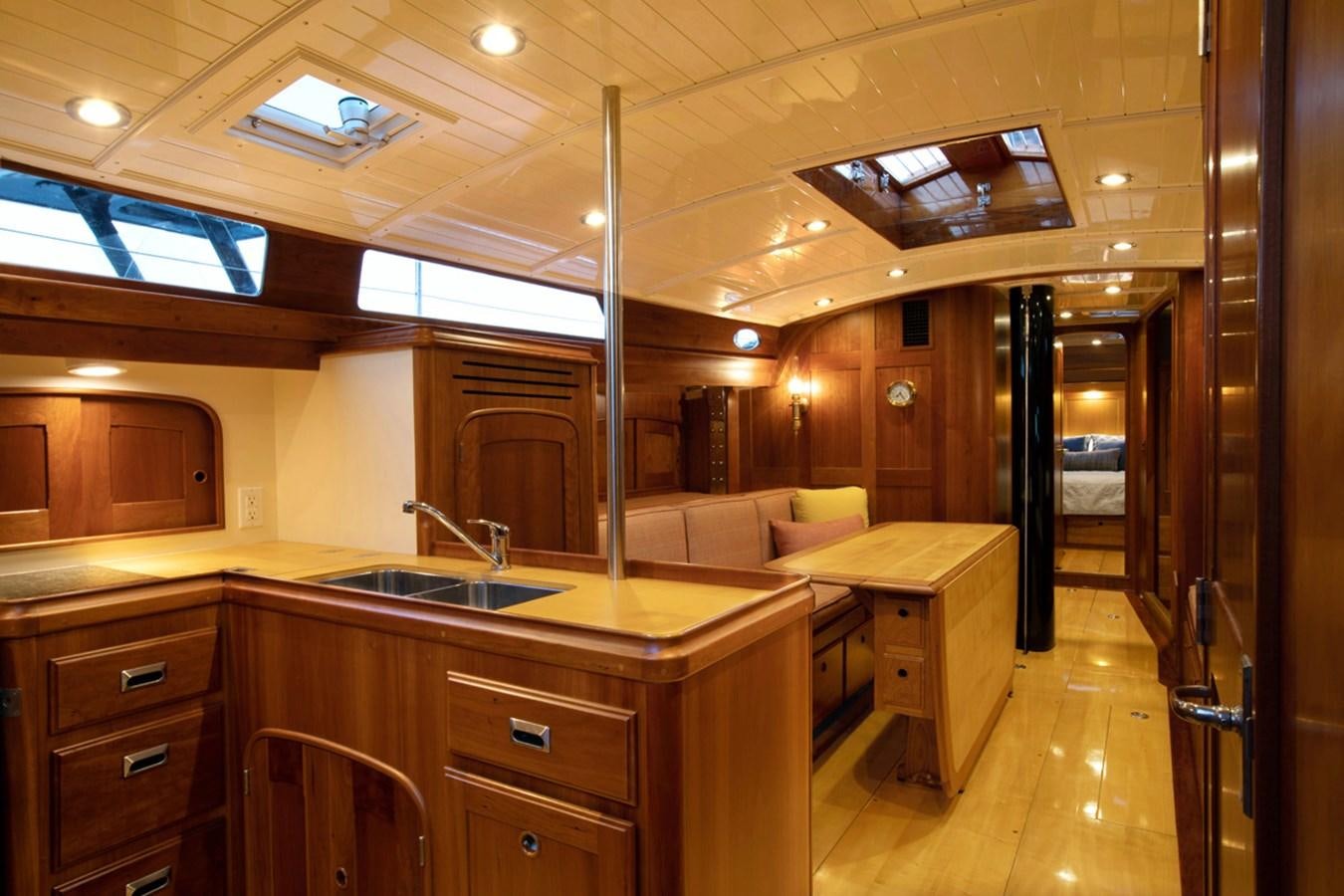 a kitchen with a sink and a couch aboard PRIVATE Yacht for Sale