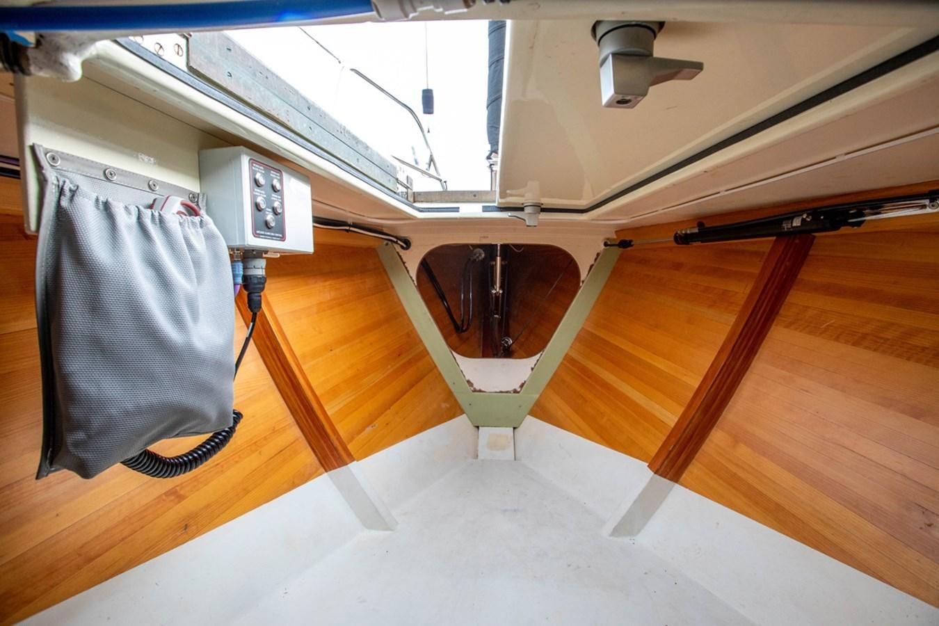 a wood table with a chair and a lamp on it aboard PRIVATE Yacht for Sale