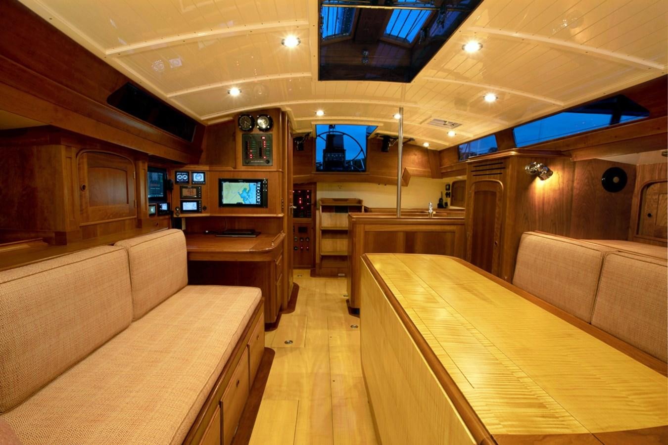 a living room with a couch and a television aboard PRIVATE Yacht for Sale