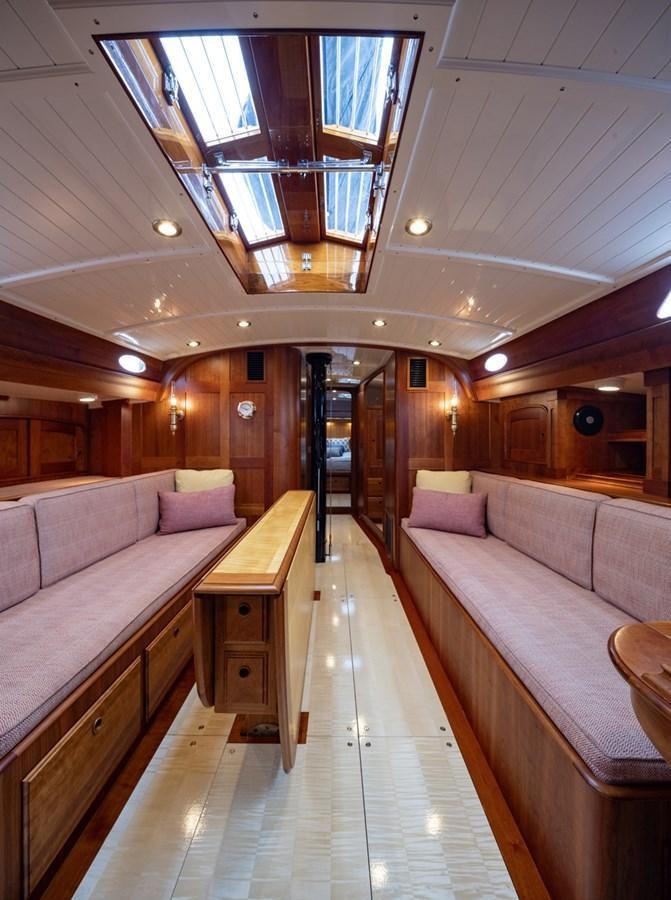 a room with a bed and a bench aboard PRIVATE Yacht for Sale