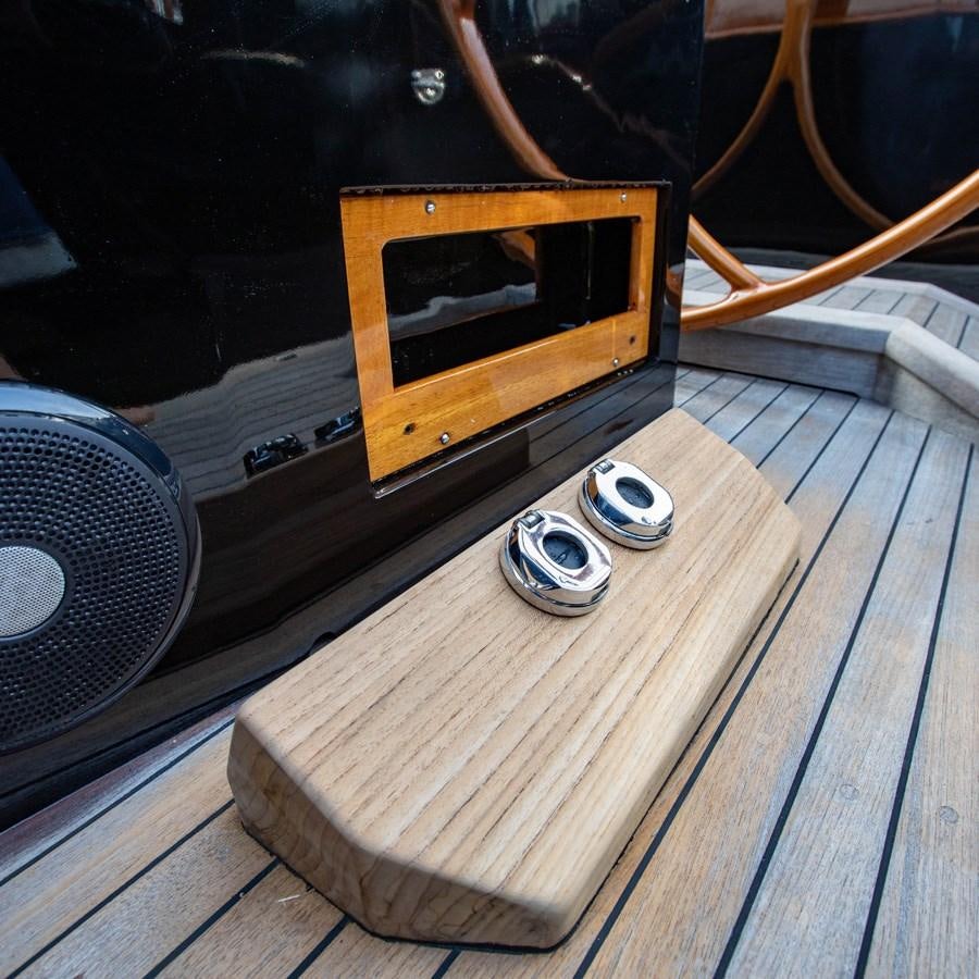 a wooden table with a speaker and a speaker on it aboard PRIVATE Yacht for Sale