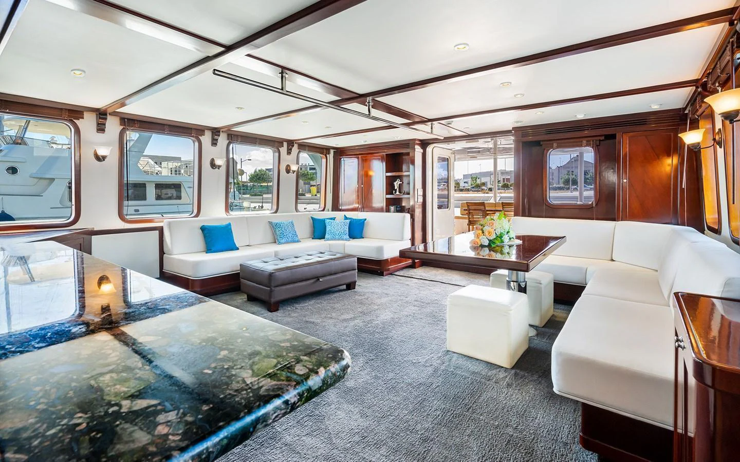 The spacious salon features elegant seating, large windows, and a sophisticated decor. aboard MISS SARAH J Yacht for Sale