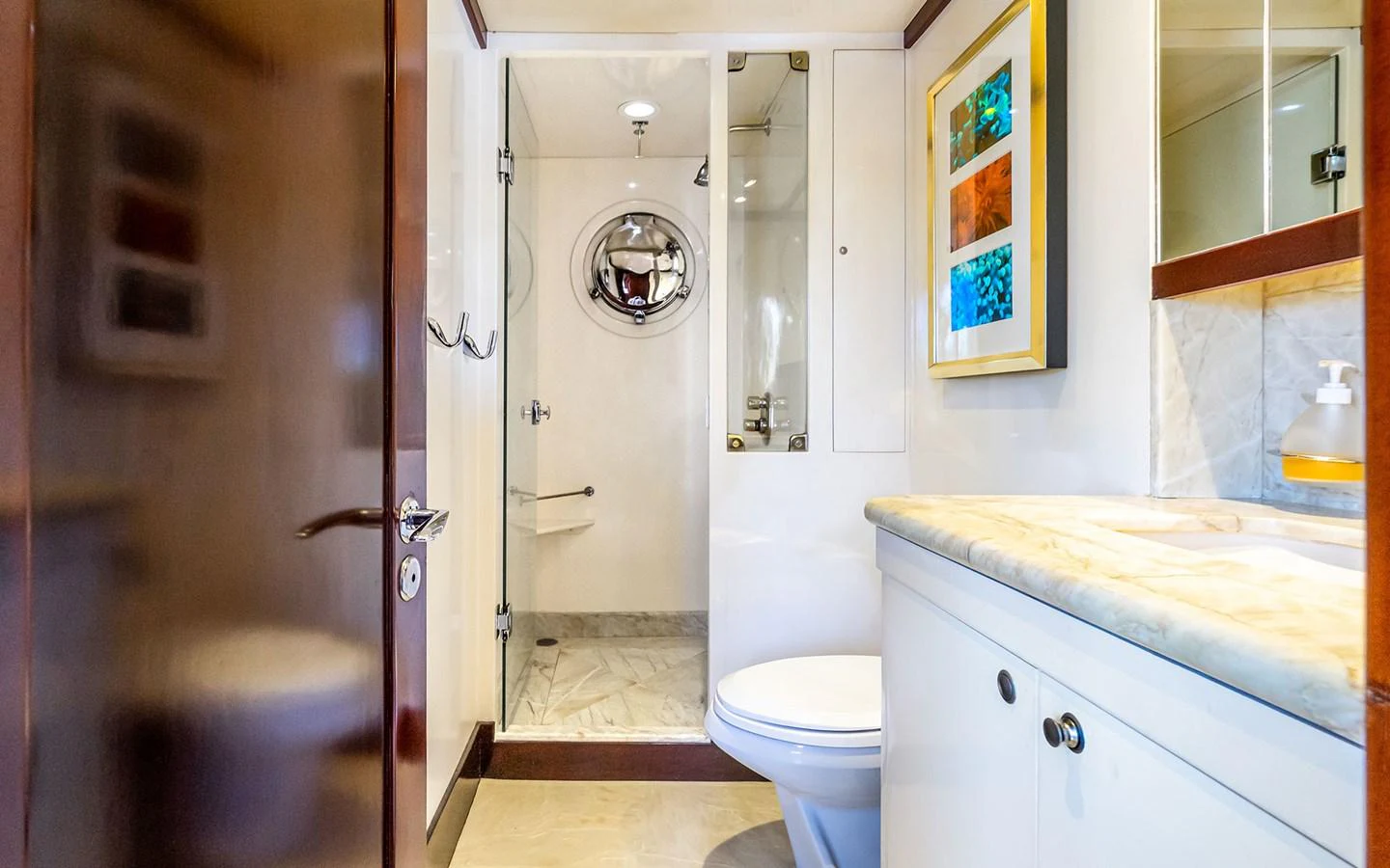 The yacht's bathroom features a modern design with a glass-enclosed shower and elegant fixtures. aboard MISS SARAH J Yacht for Sale