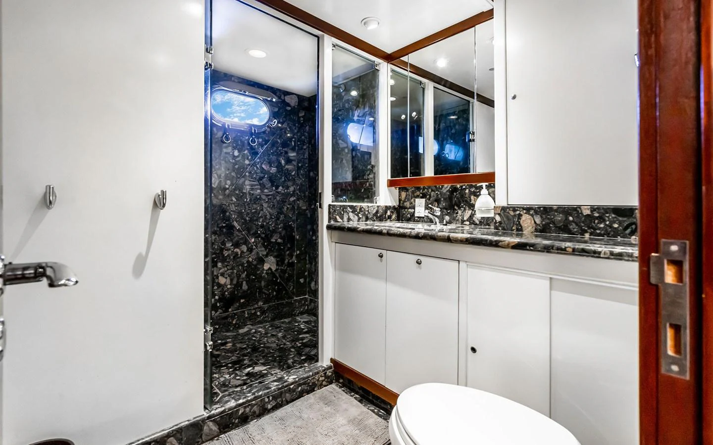 The yacht's bathroom features elegant marble accents and modern fixtures. aboard MISS SARAH J Yacht for Sale