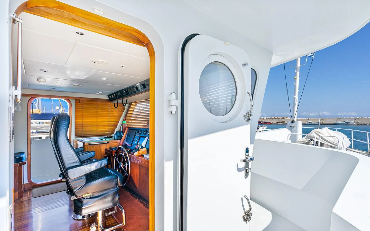 The helm area features a comfortable captain's chair and a well-equipped control station. aboard MISS SARAH J Yacht for Sale