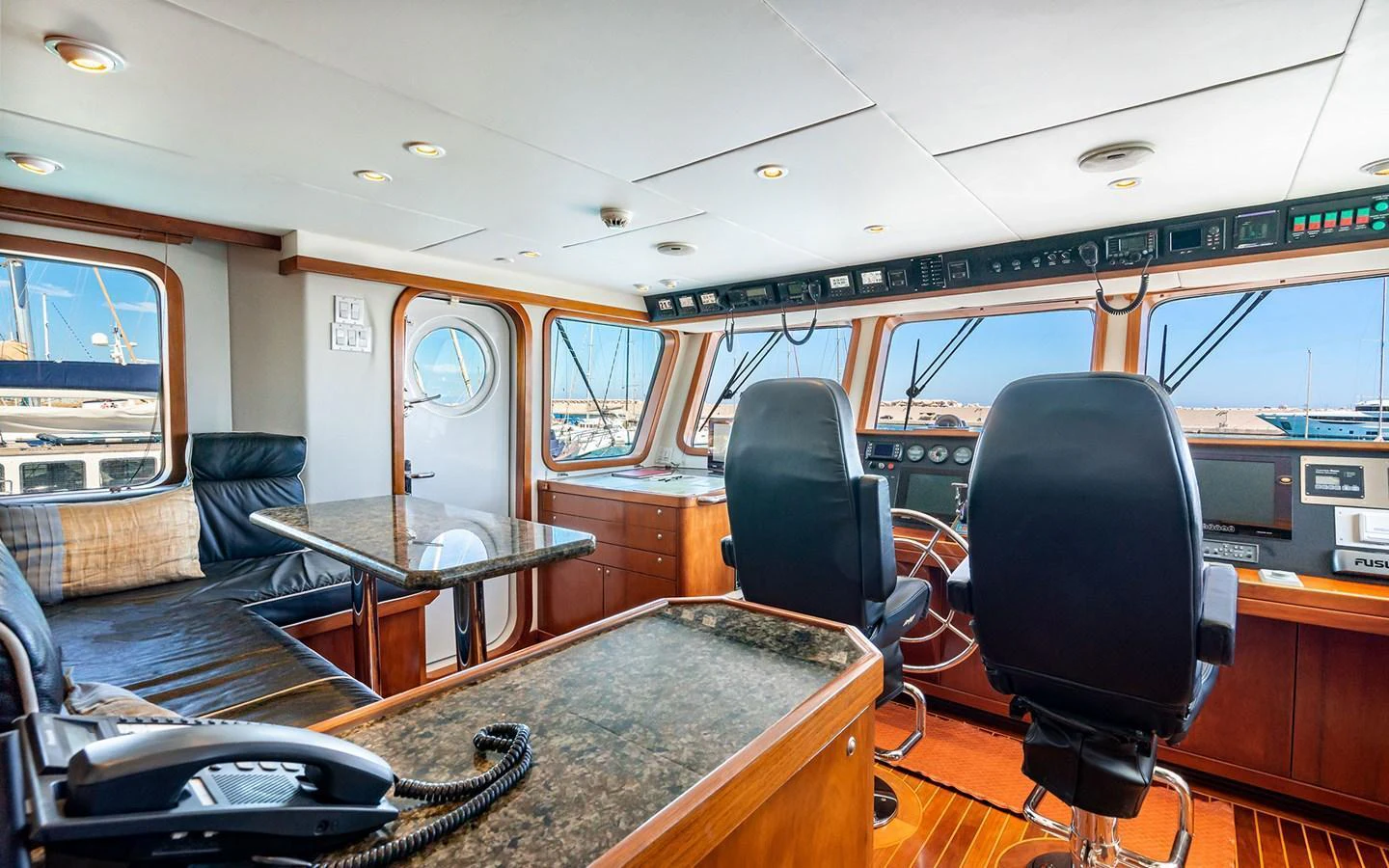 The helm station features a spacious and well-equipped control area with comfortable seating and panoramic windows. aboard MISS SARAH J Yacht for Sale