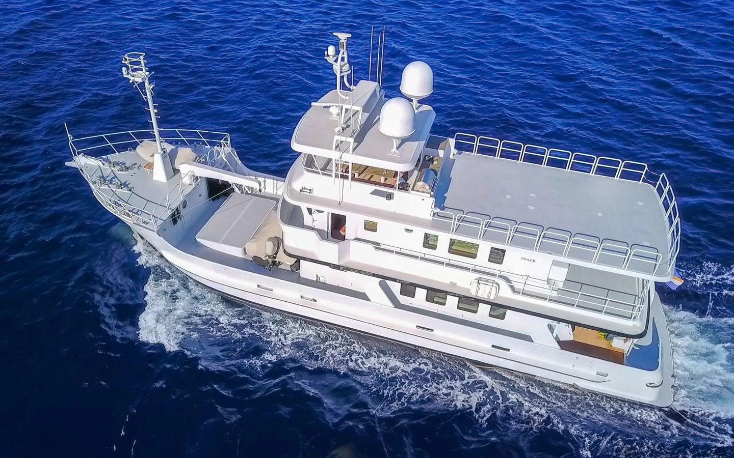 A sleek yacht cruises through deep blue waters, showcasing its modern design and spacious decks. aboard MISS SARAH J Yacht for Sale