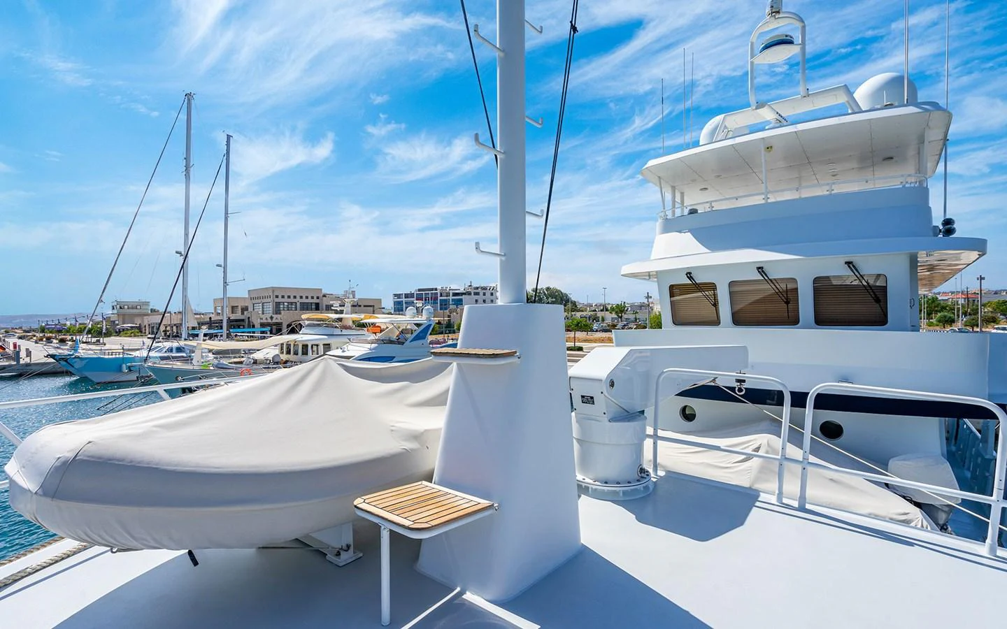 The upper deck of the yacht offers a spacious area with a covered tender and a clear view of the marina. aboard MISS SARAH J Yacht for Sale