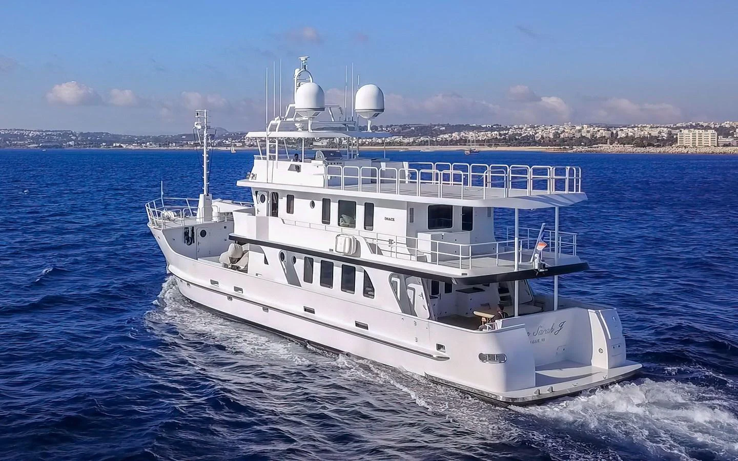 A sleek yacht cruises through the open water, showcasing its modern design and spacious decks. aboard MISS SARAH J Yacht for Sale