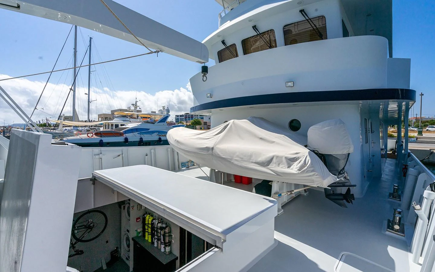 The yacht's aft deck features a well-organized storage area with covered equipment and a clean, functional layout. aboard MISS SARAH J Yacht for Sale