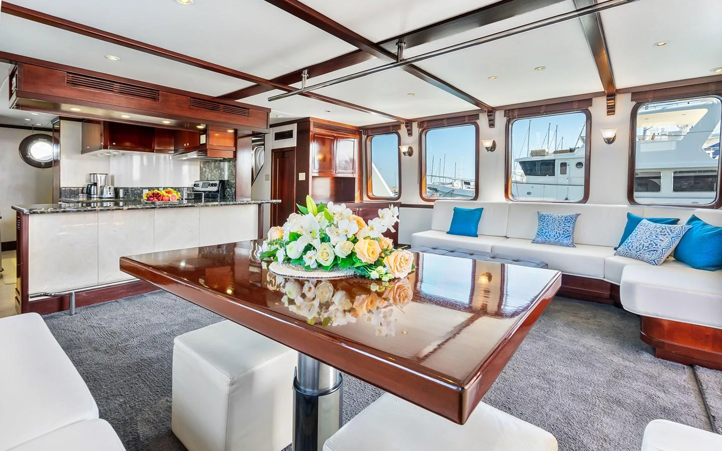 The salon features a spacious seating area with large windows and elegant decor. aboard MISS SARAH J Yacht for Sale
