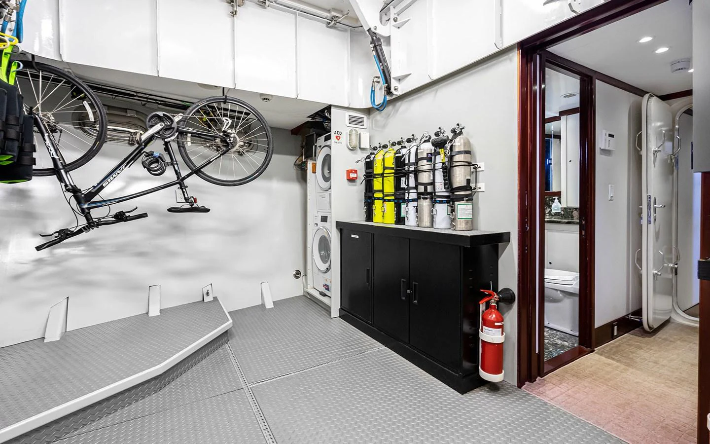 The yacht's utility room is equipped with a bicycle, scuba tanks, and laundry facilities. aboard MISS SARAH J Yacht for Sale