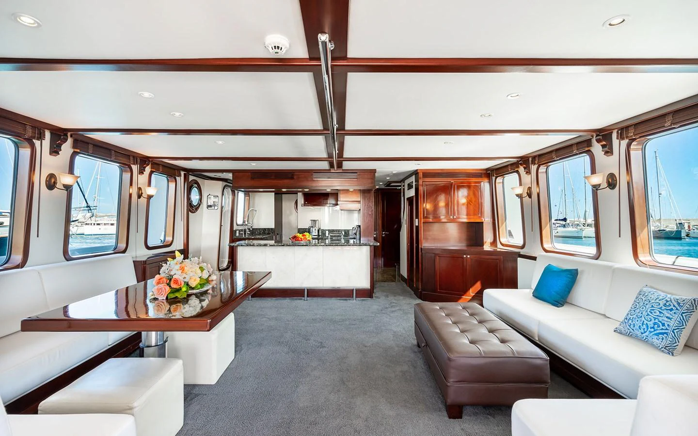 The salon offers a spacious and elegant area with ample seating and large windows providing stunning views. aboard MISS SARAH J Yacht for Sale