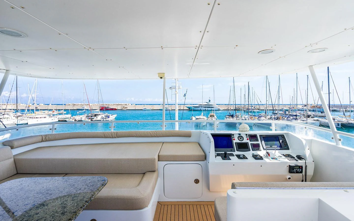 The flybridge offers a spacious seating area with a view of the marina. aboard MISS SARAH J Yacht for Sale