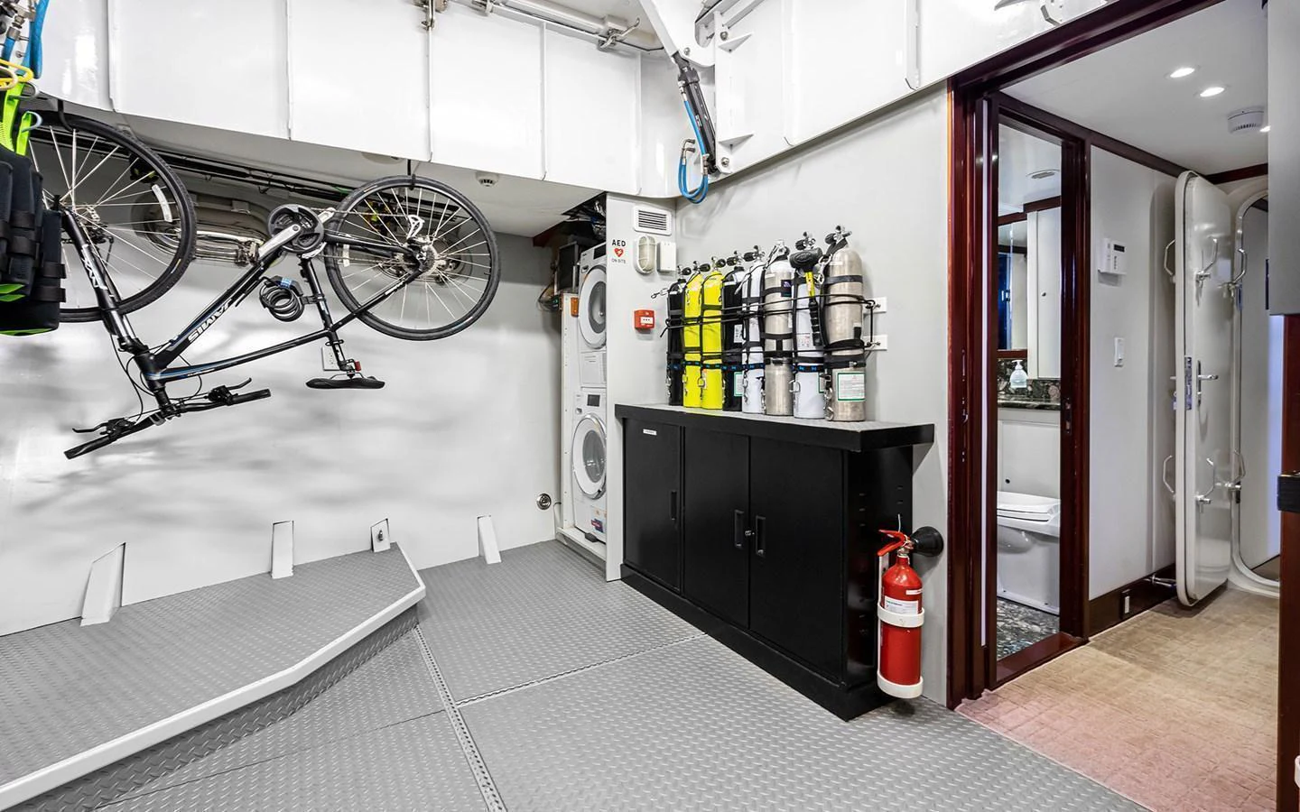 The yacht's utility room is equipped with a bicycle, diving gear, and laundry facilities. aboard MISS SARAH J Yacht for Sale