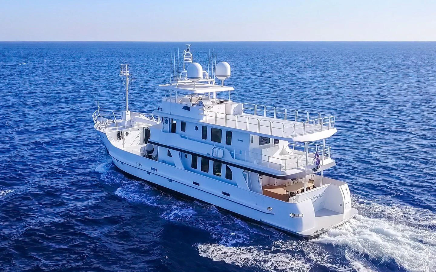 A luxurious yacht cruises through the open sea, showcasing its elegant design and spacious decks. aboard MISS SARAH J Yacht for Sale