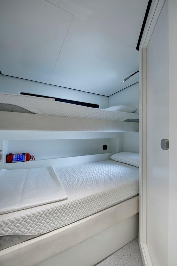a white bunk bed aboard MAZU 82 Yacht for Sale