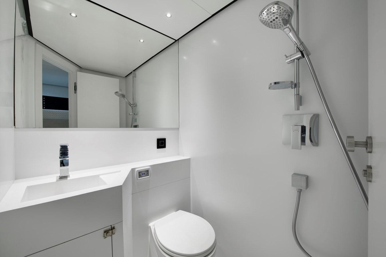 a bathroom with a toilet and a sink aboard MAZU 82 Yacht for Sale