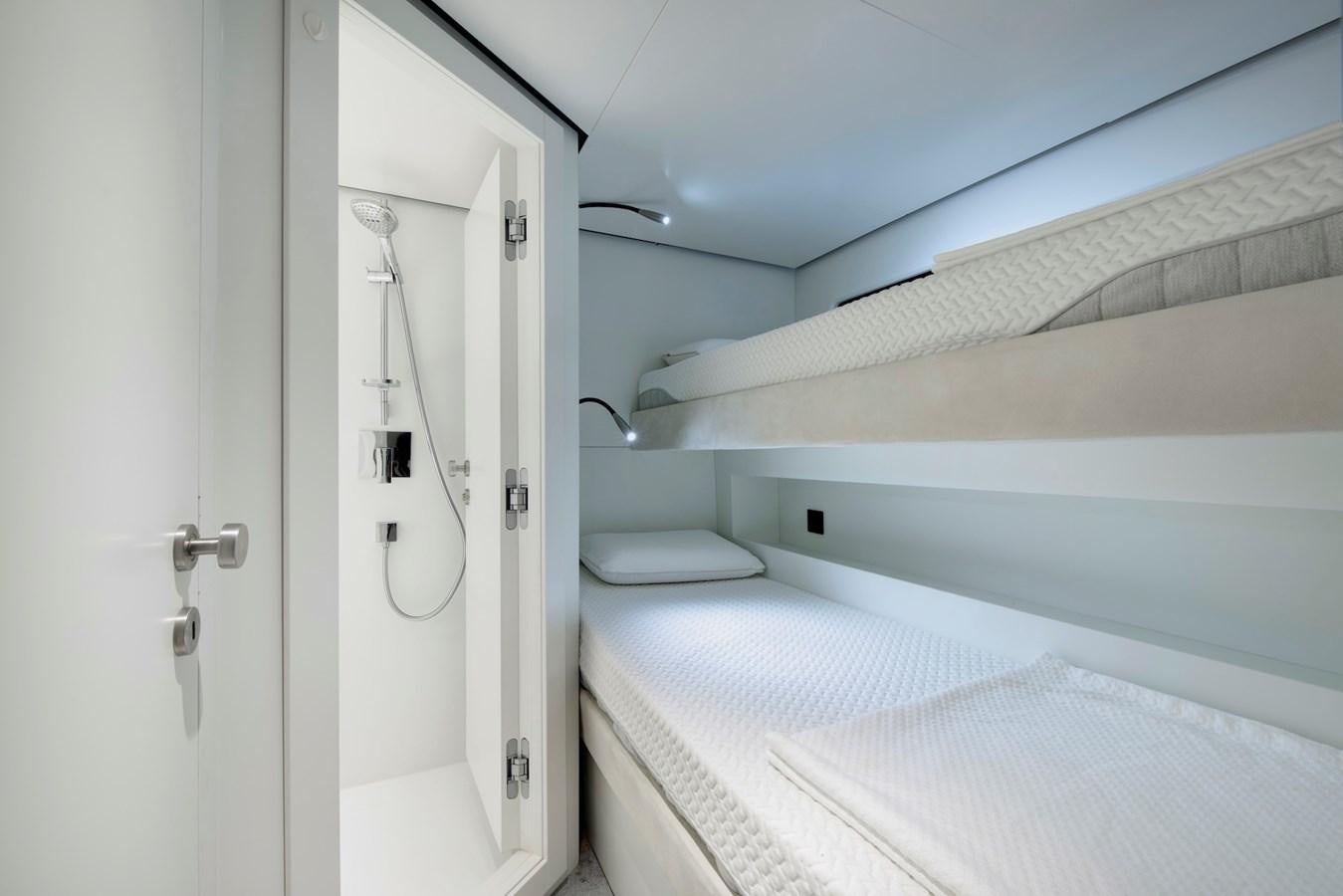 a white room with a white bed aboard MAZU 82 Yacht for Sale