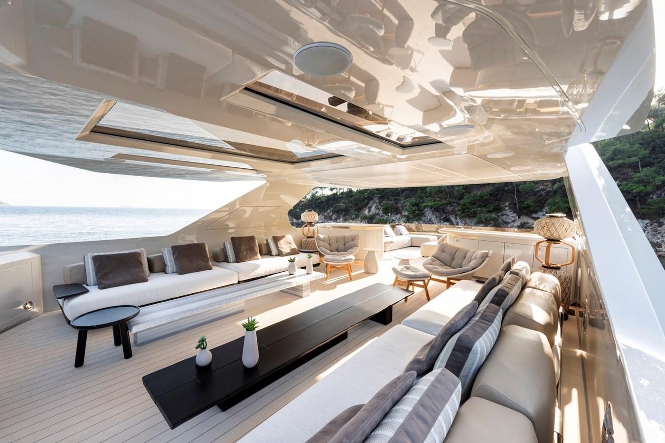 a room with a couch and a table and chairs aboard MAZU 82 Yacht for Sale