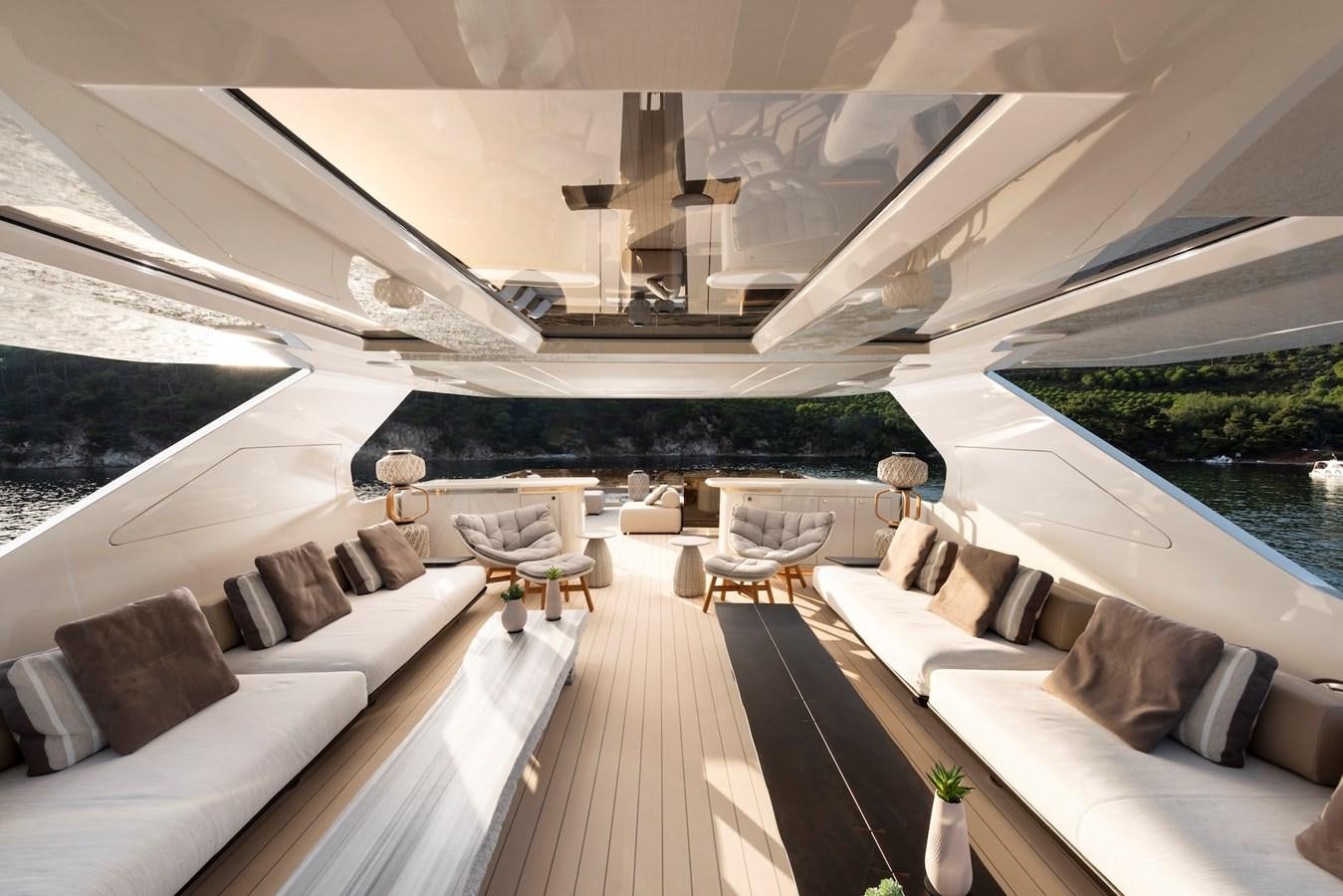 a room with a large couch and a pool aboard MAZU 82 Yacht for Sale