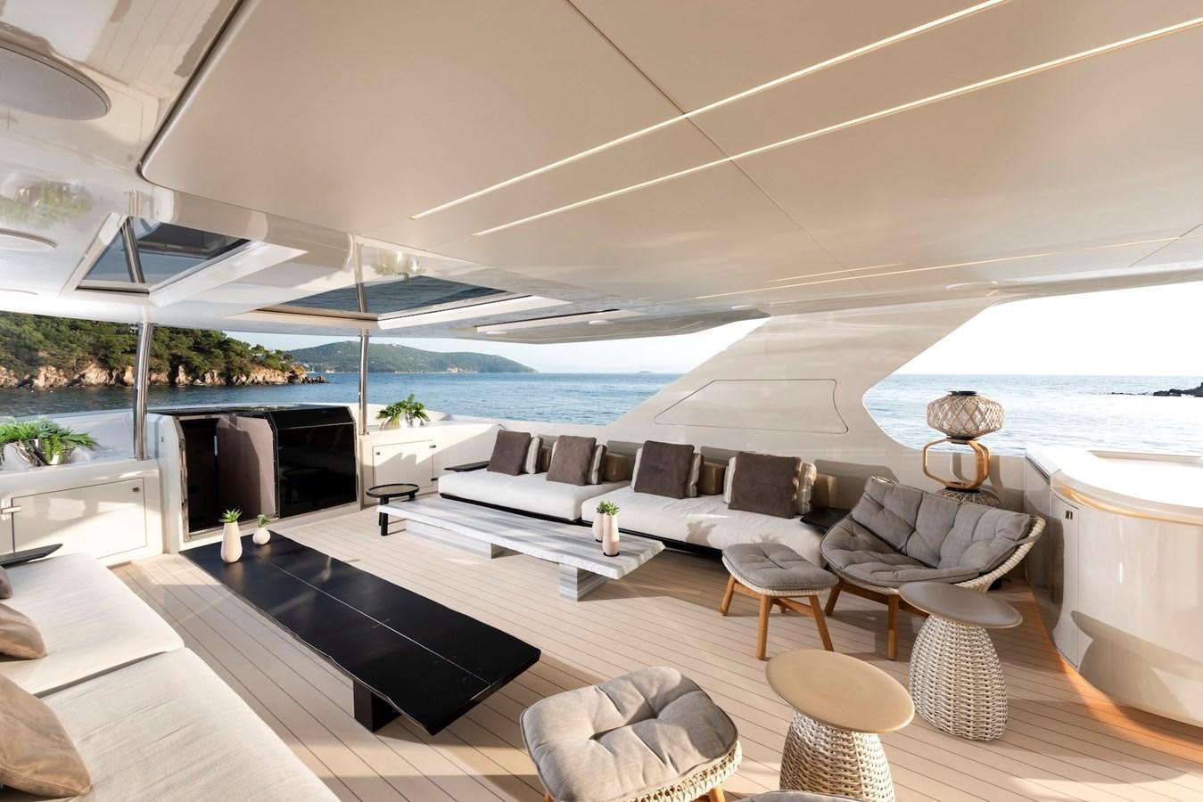 a modern living room with a large swimming pool aboard MAZU 82 Yacht for Sale