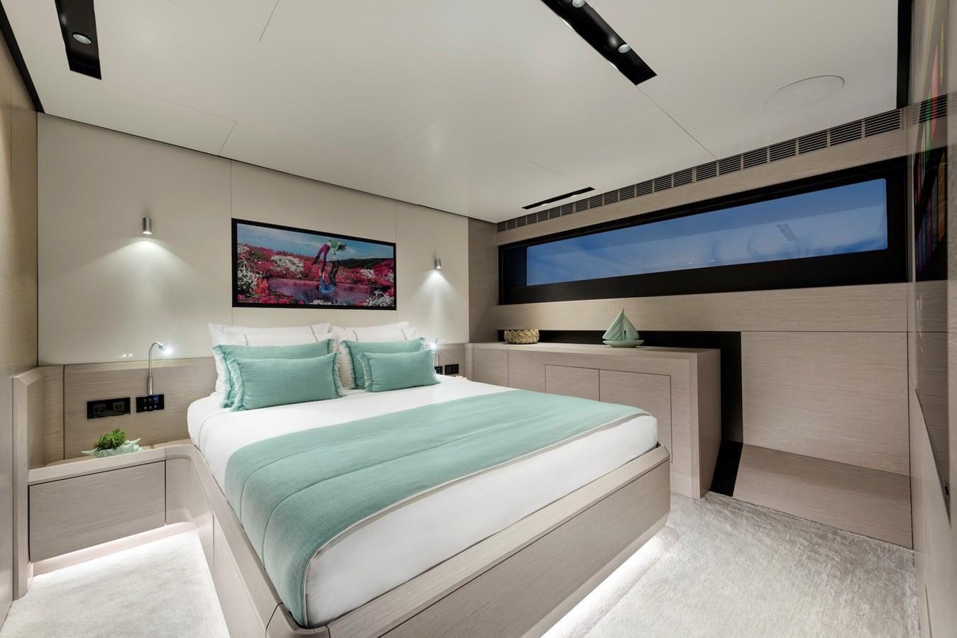 a room with a bed and a tv on the wall aboard MAZU 82 Yacht for Sale