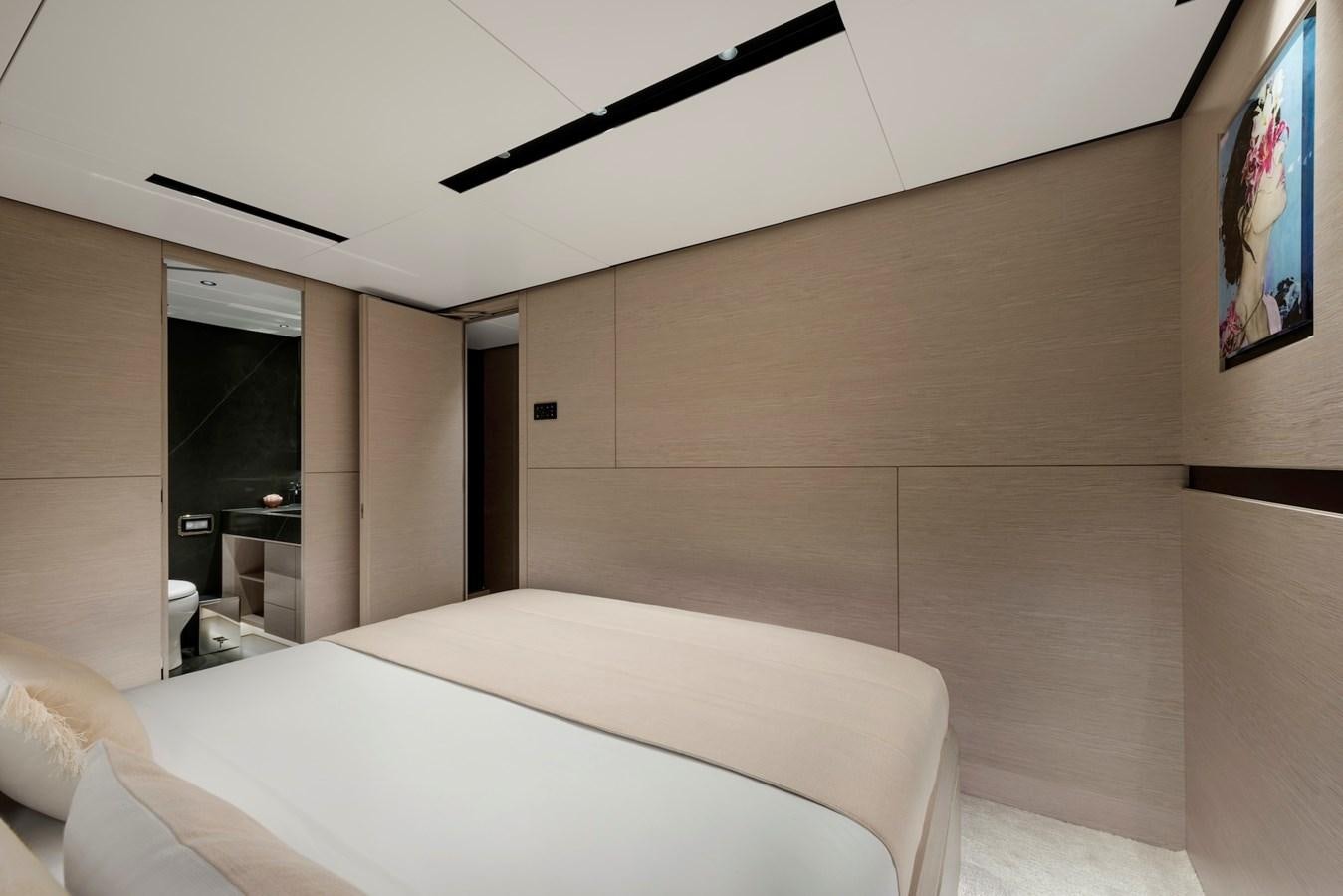 a room with a bed and a wall mounted painting aboard MAZU 82 Yacht for Sale