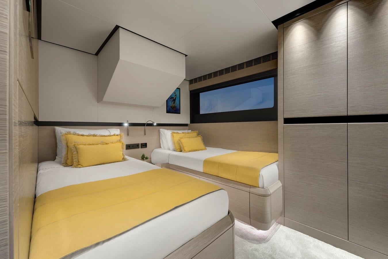a room with a bed and a tv on the wall aboard MAZU 82 Yacht for Sale