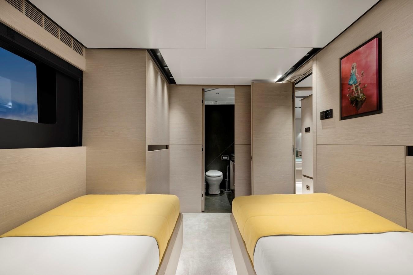 a room with a bed and a tv on the wall aboard MAZU 82 Yacht for Sale
