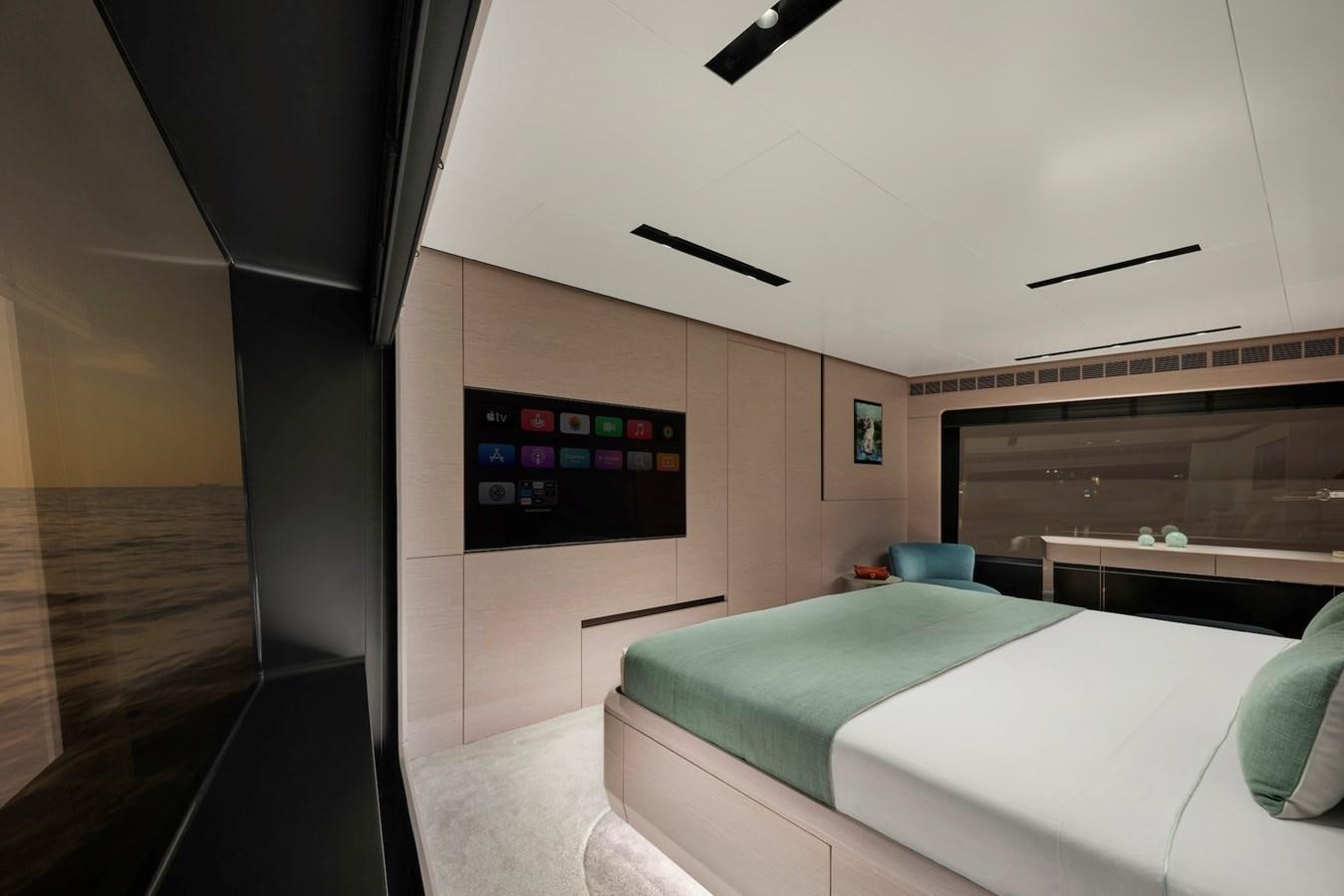 a room with a bed and a tv aboard MAZU 82 Yacht for Sale