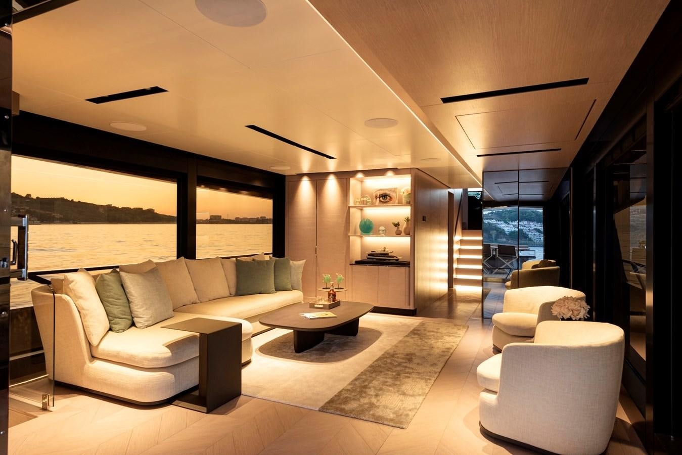 a living room with a large window aboard MAZU 82 Yacht for Sale