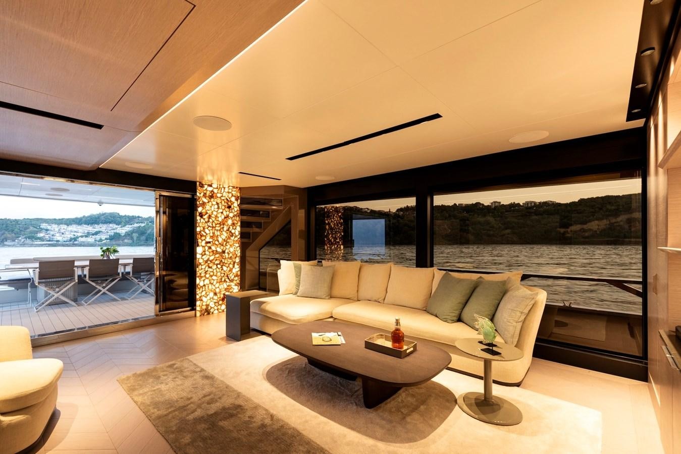 a living room with a large window aboard MAZU 82 Yacht for Sale