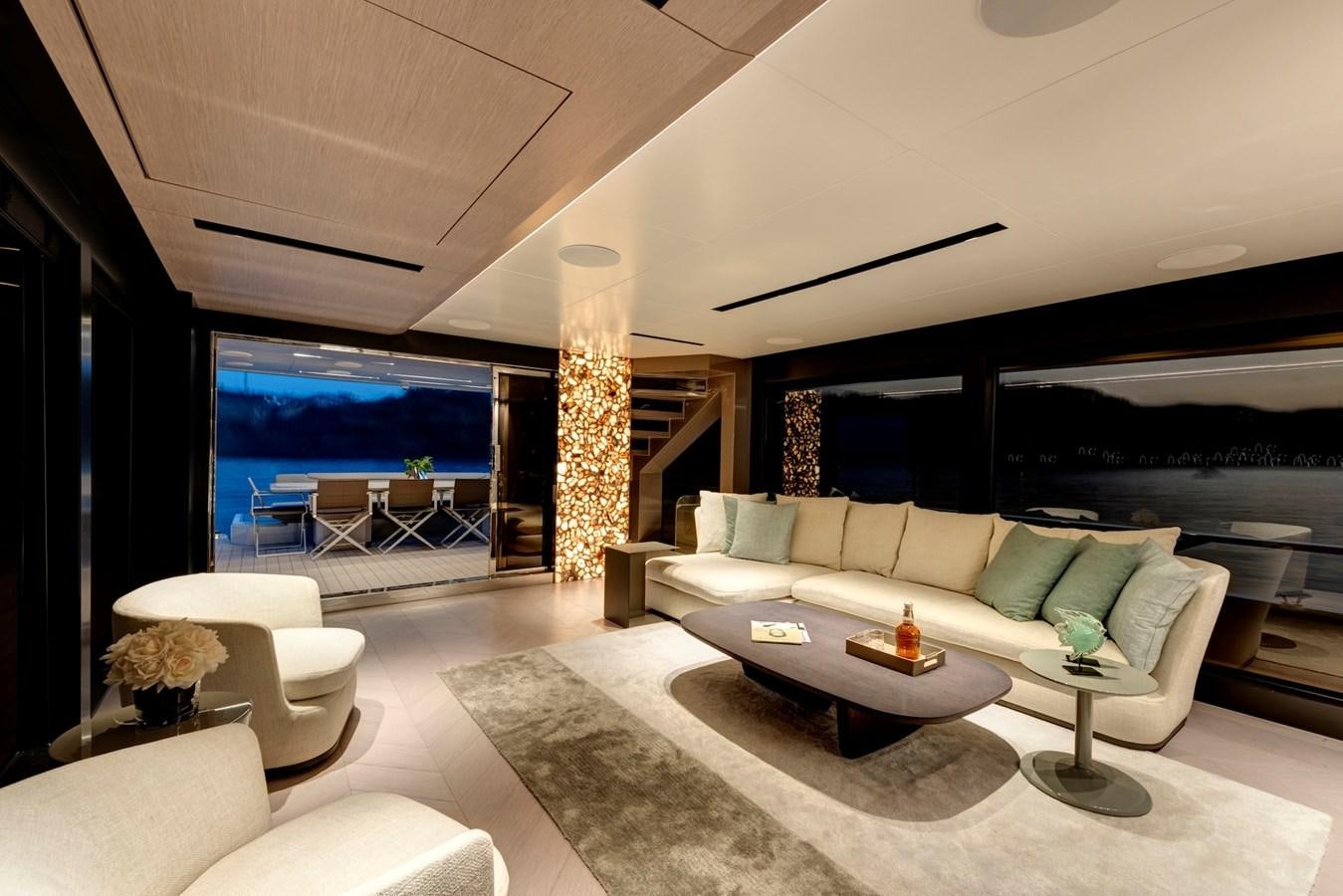 a living room with a large window aboard MAZU 82 Yacht for Sale