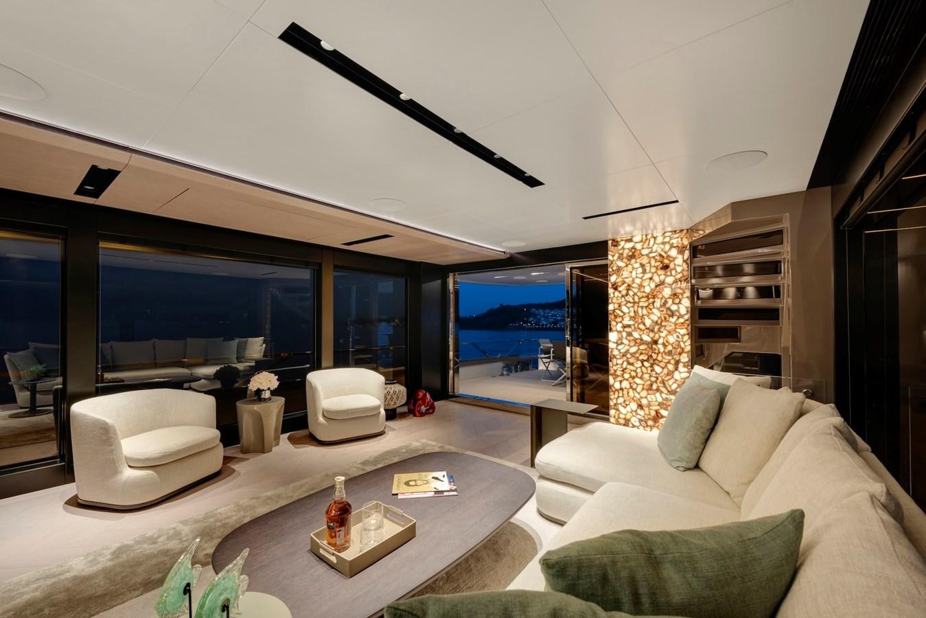 a living room with a large tv aboard MAZU 82 Yacht for Sale