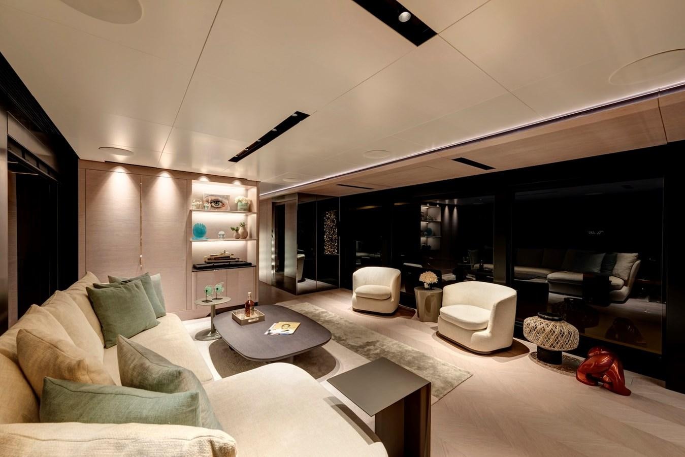 a living room with a large mirror aboard MAZU 82 Yacht for Sale