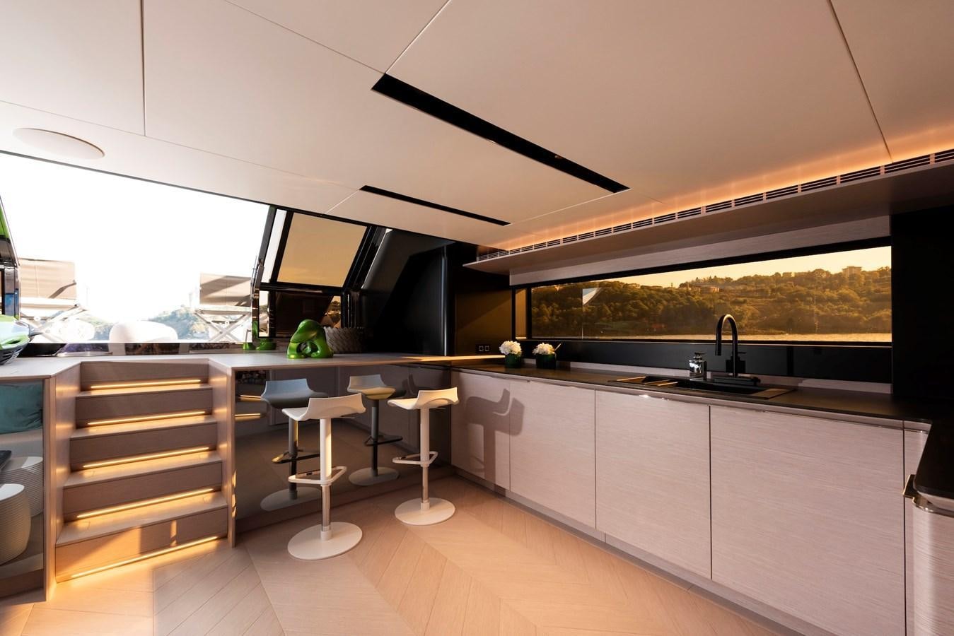 a kitchen with a large window aboard MAZU 82 Yacht for Sale