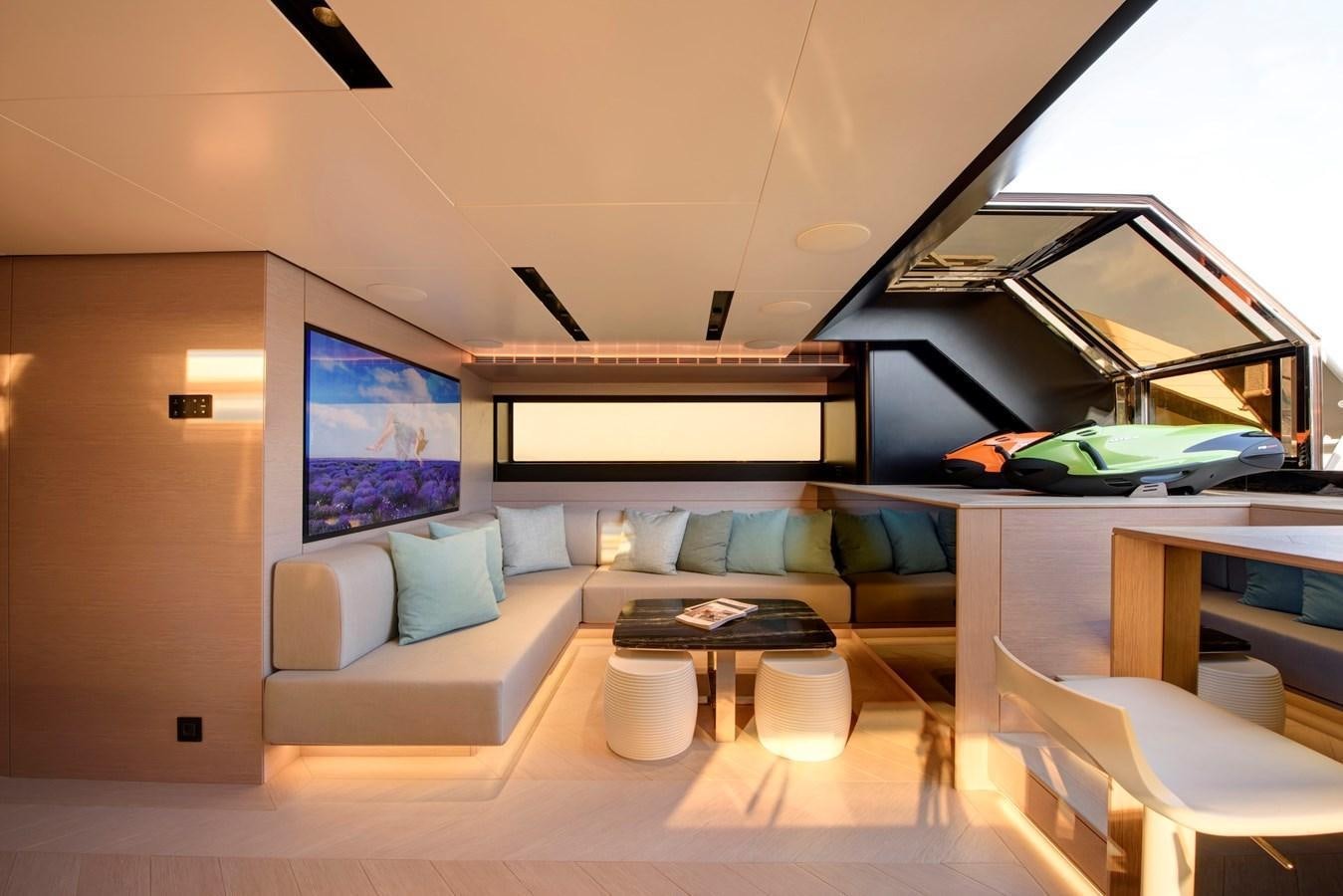 a living room with a couch and a table aboard MAZU 82 Yacht for Sale