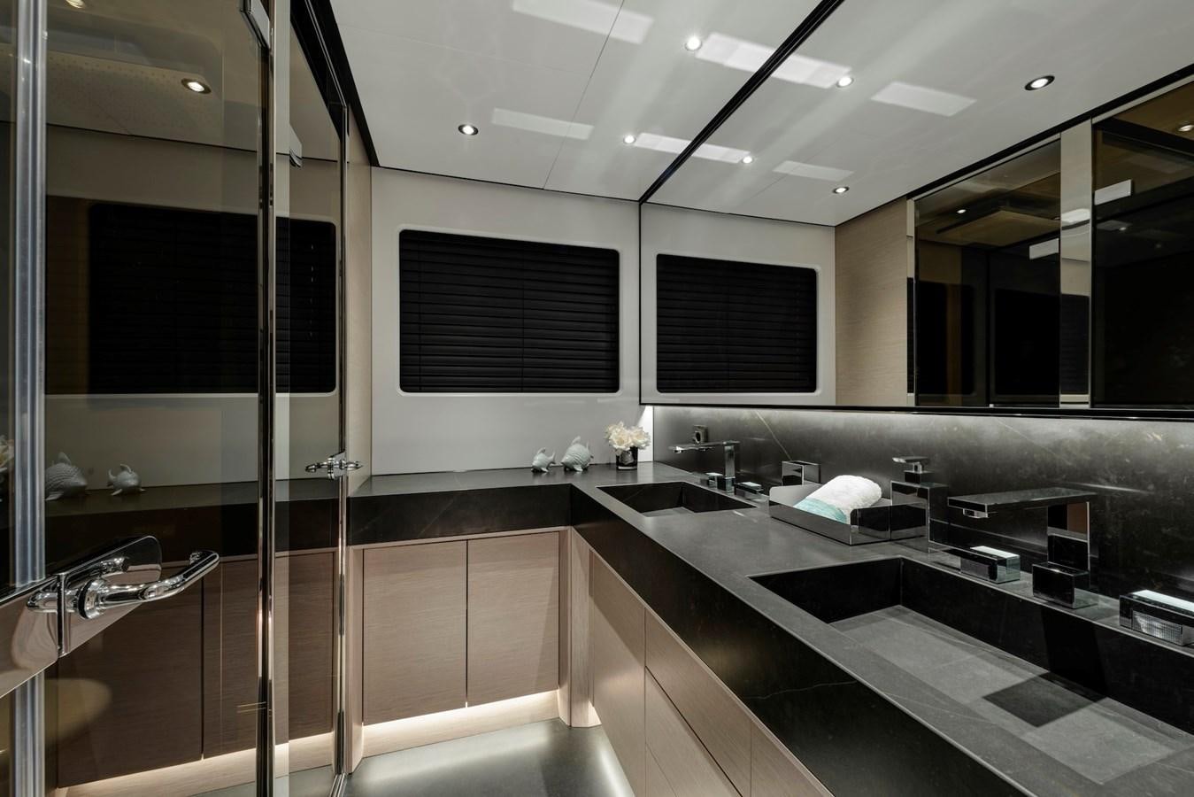 a large bathroom with a glass shower aboard MAZU 82 Yacht for Sale