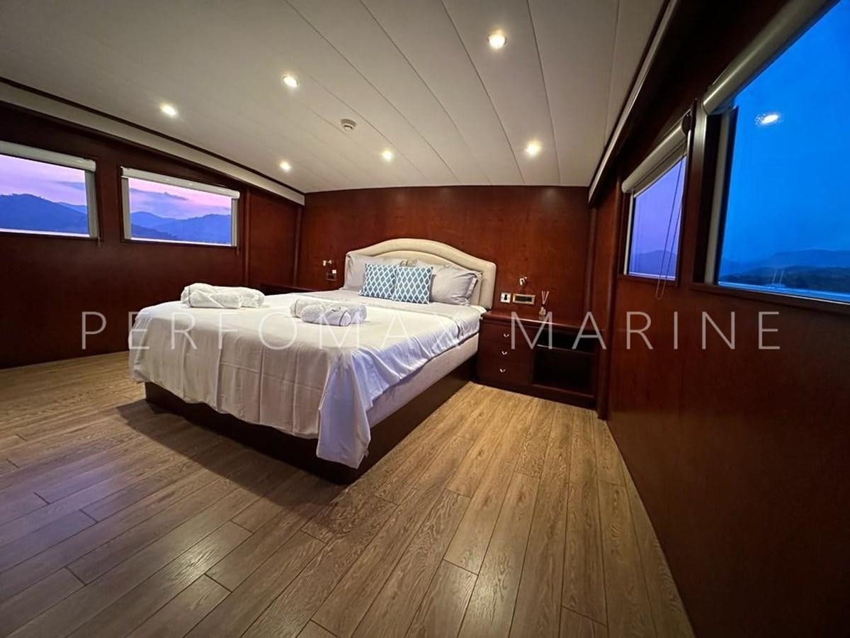 a room with a bed and a window aboard M/Y TUZLA 27M Yacht for Sale