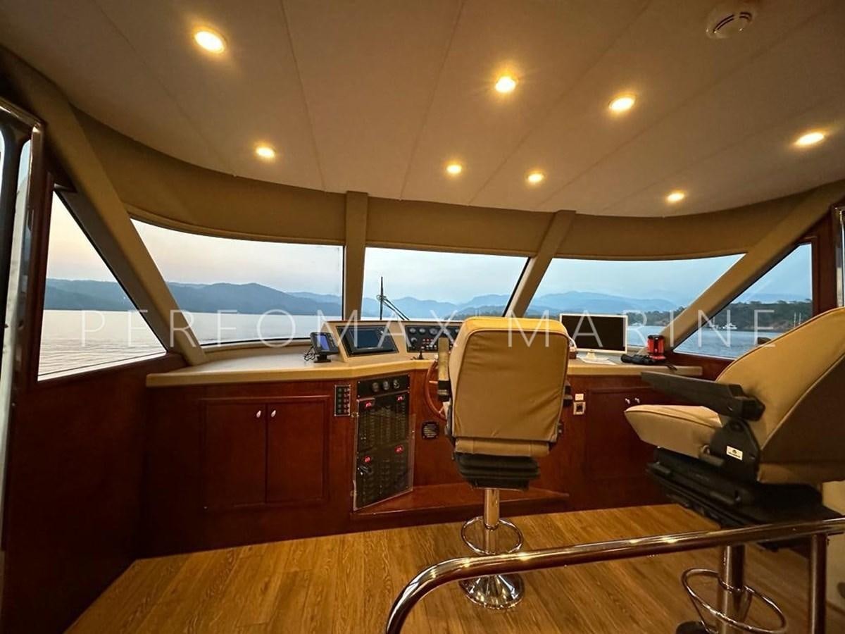 a room with a desk and chairs aboard M/Y TUZLA 27M Yacht for Sale