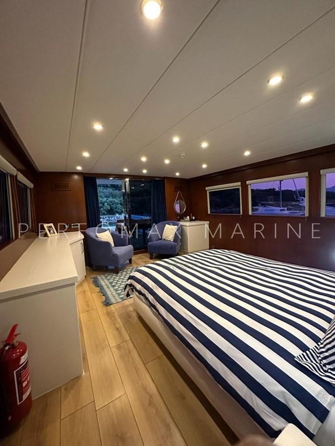a room with a bed and a couch aboard M/Y TUZLA 27M Yacht for Sale