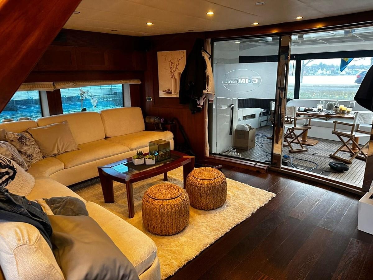 a living room with a glass door aboard CONAM 65 FLYBRIDGE Yacht for Sale