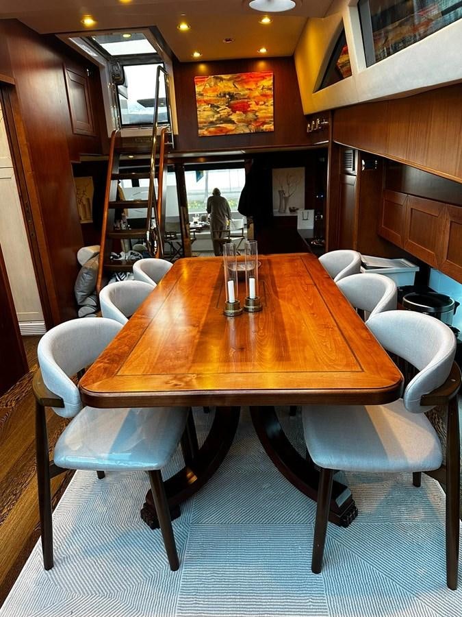 a table with glasses on it aboard CONAM 65 FLYBRIDGE Yacht for Sale
