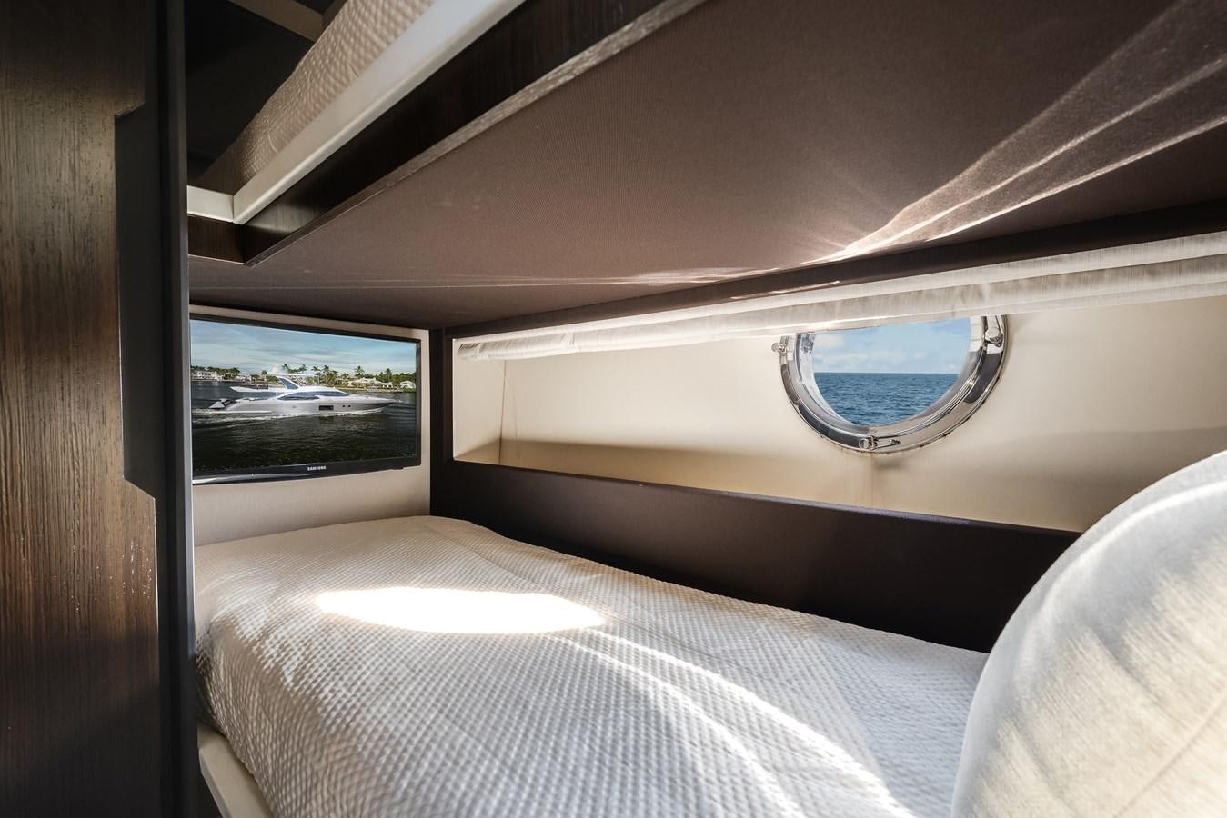 a bed with a round window aboard TRUTH SERUM Yacht for Sale