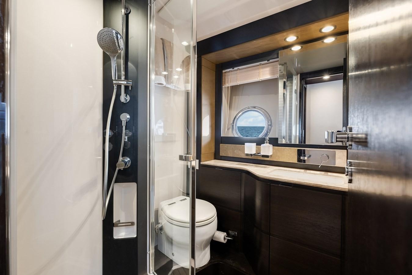a bathroom with a glass shower door aboard TRUTH SERUM Yacht for Sale